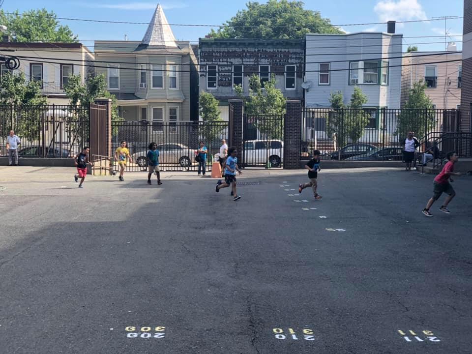 several kids running in the playground