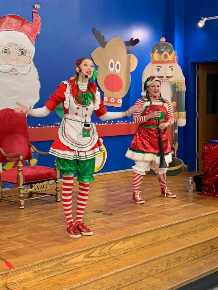 two elf performers singing