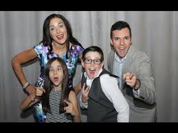 Family in photo booth being silly